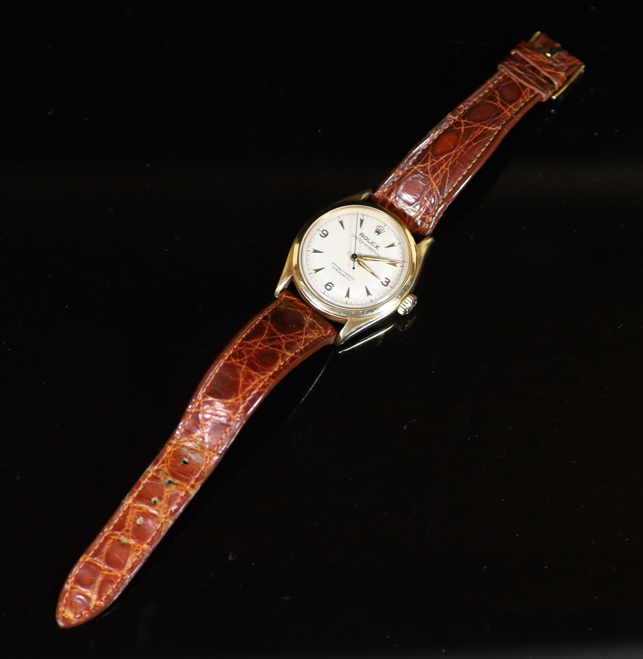 A gentleman's early 1950's 9ct gold Rolex Oyster Perpetual bubbleback wrist watch, on a leather strap with gold plated Rolex buckle